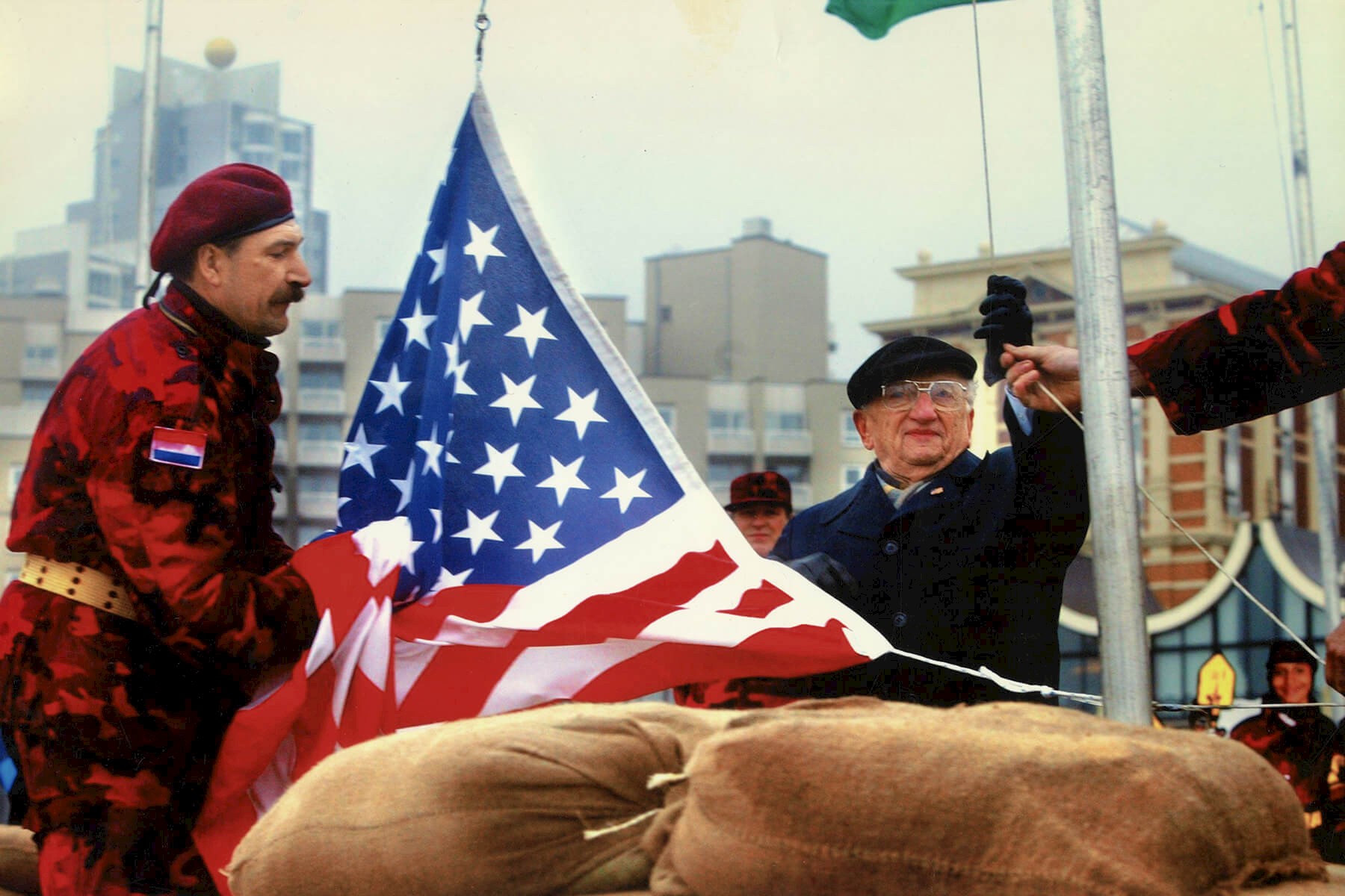 Ben Ferencz raises U.S. flag, The Hague, Netherlands. March 2003.