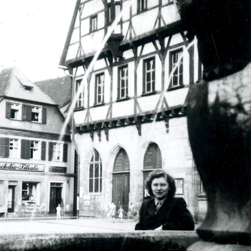 Gertrude standing by a water fountain while traveling to Nuremberg, May 1947